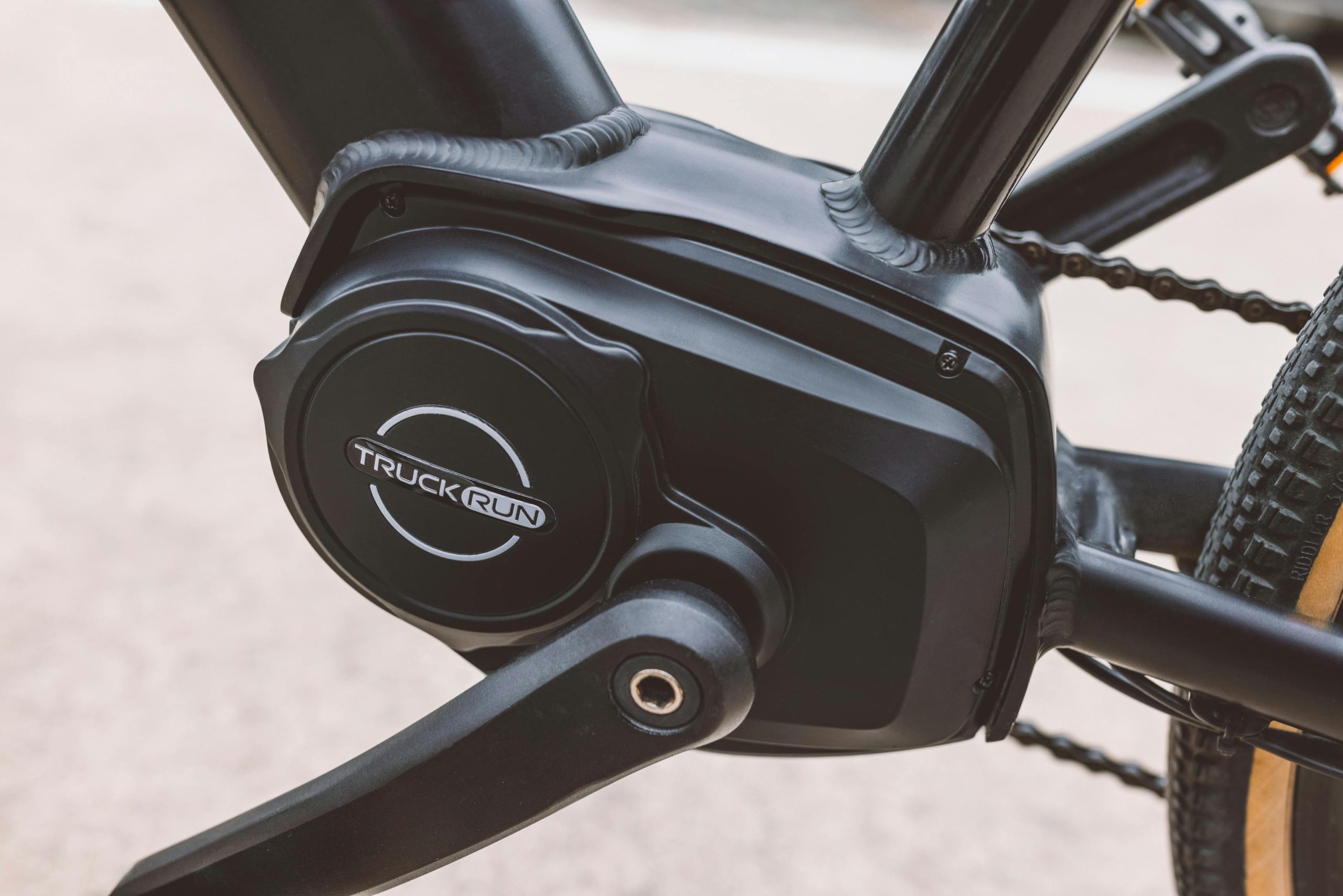 Detailed close-up image of a black electric bicycle motor and pedal system.