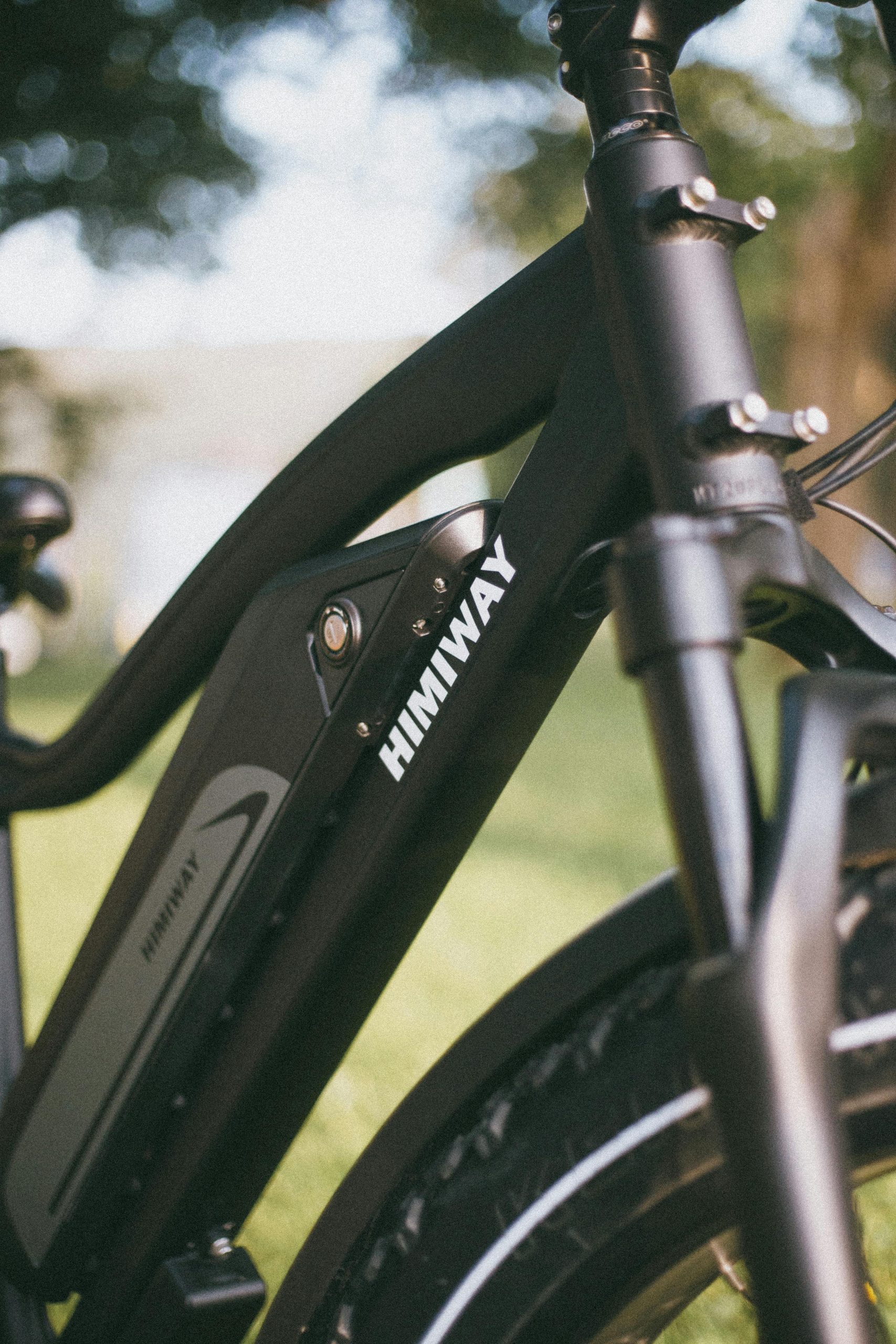 Detailed view of a Himiway electric bike parked in a sunlit outdoor setting.